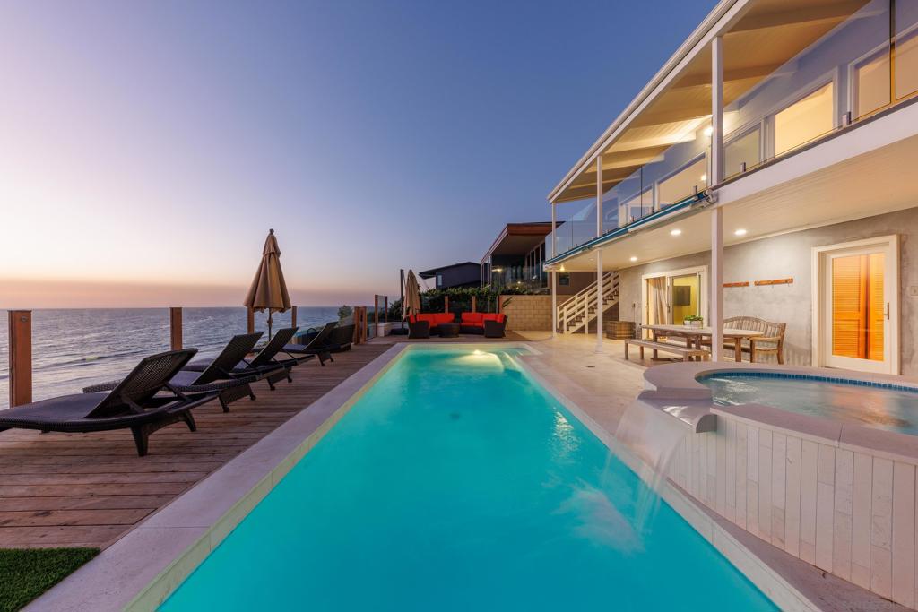 Exceptional Coastal Living with Private Beach Access! Discover the perfect blend of comfort and coastal living in this recently remodeled 5BR, 3BA home. Perched on an oceanfront bluff, this one-of-a-kind home boasts a spacious deck overlooking the sparkling Pacific as well as private steps that lead down to the beach. Soak in the oceanfront pool or spa, or take in the unbeatable views while enjoying the home's fire pit, BBQ, yard, or outdoor shower. Designed to accommodate up to 12 people, this spacious home is furnished with ample sleeping arrangements, offering 2 King Beds, 1 Queen Bed, 2 Full Beds, and 2 Twin Beds. The entry level of the home, along with the home's living, dining, and kitchen areas, offers a guest bedroom with a Queen bed and guest bathroom. The gourmet kitchen boasts ocean views, top-end appliances, and an indoor grill. Upstairs you'll find the tranquil primary retreat, boasting ocean views from a King bed, a private deck, and an ensuite bathroom. The top level also offers an additional guest room with 2 Full beds and stunning views. The lowest level of the home boasts spacious accommodations with two guest rooms, one with a Full and Twin bed and the other with a King bed. This level also includes a full guest bathroom, a family room, and access to the the oceanfront deck. Step out onto the perfectly appointed deck to enjoy a swim in the pool, soak in the hot tub, or lounge in one of the many cozy seating areas. If you're looking to head to the beach, enjoy private stairs down to the beach from your deck. This home features beautiful vaulted ceilings, a gourmet kitchen with stainless steel appliances and granite countertops, and a washer/dryer. For your ultimate enjoyment, the home is equipped with central heating and air, as well as two split systems with remote controls in the bedrooms located on the top floor for individual climate control. The home also comes equipped with solar panels for clean electrical energy. Ideally located and secure for your comfort and convenience, this fully furnished 3-story home, is gated and offers ample garage and driveway parking. This property offers the ideal setting for a relaxed, coastal lifestyle.