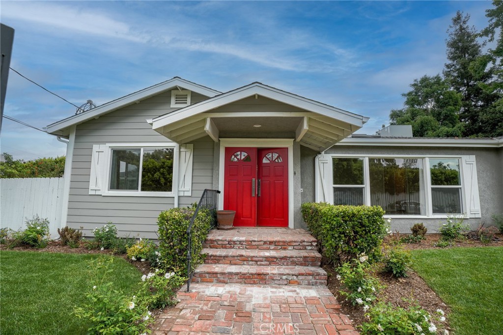 This stunning single-story home has been completely remodeled and offers three spacious bedrooms, three bathrooms, and a versatile den. Enter through double doors into a bright, open living room with oversized windows, a cozy wood-burning fireplace, and a Velux skylight that brings in natural light. The large, remodeled kitchen features sleek white cabinetry, custom quartz countertops, brand-new stainless steel appliances, and two pantry cabinets for generous storage. A charming breakfast area with laundry hookups opens to a beautifully landscaped yard, perfect for outdoor enjoyment. The separate den, with large windows and direct access to the yard, provides a flexible space to suit your needs. The expansive primary bedroom includes its own wood-burning fireplace and doors leading to the backyard. The brand-new en-suite bath features a walk-in shower, separate soaking tub, quartz countertops, a Velux skylight, and an attached walk-in closet. Two additional generously sized bedrooms and updated bathrooms maintain the home’s fresh, contemporary feel. This home also boasts all-new dual-pane windows, beautiful oak hardwood floors, and central heating and air conditioning. The private, professionally landscaped backyard offers a lush green lawn with ample space to play, garden, or entertain. A detached, oversized two-car garage with built-in storage provides additional convenience. Other features include a brand-new roof, fenced front and rear yards with a locked entry gate, and plenty of additional parking on a private street. Centrally located south of Riverside in Valley Village, this home is close to shopping, dining, and freeway access. Elegant, tasteful, and fully remodeled, this home is truly move-in ready!