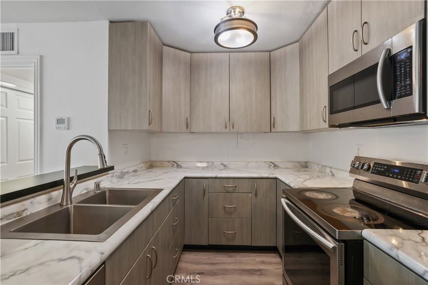 This beautifully updated 2-bed, 2-bath Valencia condo features two primary bedrooms, brand-new carpet, newer energy efficient HVAC system and fresh interior paint throughout. Enjoy neighborhood views from your private patio, plus one covered and one uncovered parking spot. Conveniently located near the 5 freeway and downtown Newhall, with water, trash, and sewer included in the HOA. Move-in ready and perfectly situated for easy living!