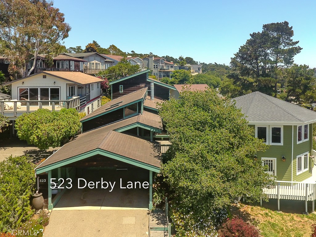 HAPPY HILL OCEAN VIEWS: EXPERIENCE PARADISE! Nestled on a quiet cul-de-sac, this 3-bedroom, 3-bathroom redwood home offers 2,417 square feet of light-filled living space featuring vaulted cedar ceilings and cedar walls. A beautifully crafted, wood-burning brick fireplace with a gas starter—perfect for cozying up on those chilly Cambria nights. The flexible layout includes two primary suites—one upstairs and one down—ideal for guests or multi-generational living. The upstairs primary suite showcases ocean views of Moonstone Beach, two walk-in closets, a private balcony, and a spacious en-suite bathroom. The downstairs suite also includes ocean views and a walk-in closet. The spacious kitchen has a walk-in pantry, prep island with sink, modern appliances and ample cabinetry and counter space. Additional highlights include an airy library with loft and built-in nooks, plus an extra loft in the guest bedroom—providing creative and relaxing spaces. Transom windows, skylights, ample built-in storage throughout and the convenience of indoor laundry. Outside, enjoy sipping wine on the sunny deck, a low-maintenance yard with mandarin, orange, and lemon trees, adding a touch of coastal garden life. Located just blocks from Cambria’s West Village and Moonstone Beach, with easy access to shopping, dining, and wine tasting—this home perfectly blends comfort, character, and a highly desired location.