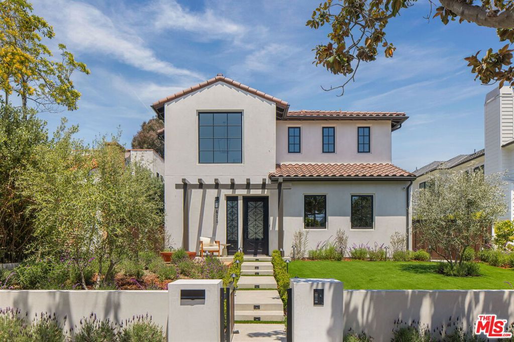 Discover this newly constructed Spanish-style gem nestled on a tranquil, tree-lined street north of Montana Avenue in Santa Monica. This 5-bedroom, 5.5-bathroom residence spans 4,156 sq ft, featuring a main house, a JADU, and an ADU, with laundry. A picturesque front yard welcomes you with multi-trunk olive trees and a charming fountain, setting a serene tone. Inside, the home boasts Calypso oak flooring throughout and reclaimed wood ceiling beams that add warmth and character. The chef's kitchen is equipped with Thermador appliances, a custom hood, and a wine refrigerator, perfect for culinary enthusiasts.Designed for seamless indoor-outdoor living, Marvin French doors open to a luminous backyard oasis. Enjoy the gas-heated pool with a tranquil water feature, a built-in Lynx BBQ complete with sink and refrigerator, and landscape lighting that sets the perfect ambiance for evening gatherings. The JADU and the great room open to a courtyard, offering an intimate space for relaxation or entertaining. Smart home features are controlled via an included iPad, managing lighting, motion cameras, and a Sonos sound system with exterior speakers in both the courtyard and pool area. Additional highlights include wrought iron stair railings, solid wood stained interior doors, and a two-car garage accessible from the alley. This thoughtfully designed home offers a perfect blend of luxury, comfort, and outdoor entertaining in a prime Santa Monica location.
