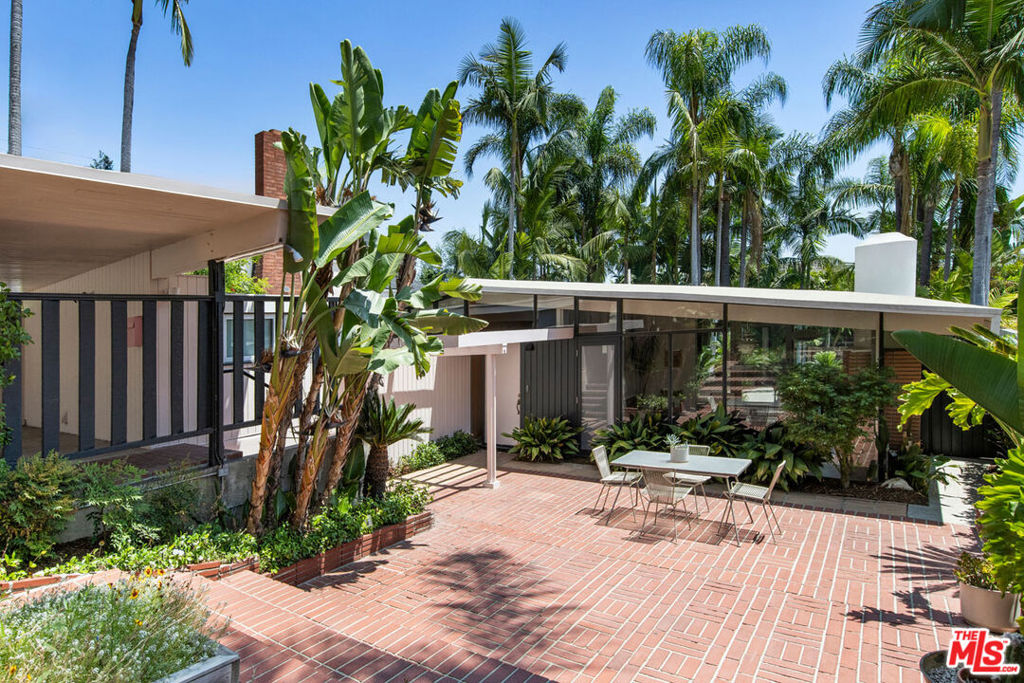 A rare opportunity to own a significant work of midcentury modern architecture by A. Quincy Jones FAIA, one of just three "Sun Villa" residences built in Los Angeles. Completed circa 1950, the updated home showcases Jones's signature post-and-beam design, where volume, light, and material harmonize across an expansive indoor-outdoor layout. Clerestory windows and glass sliders invite sunlight into airy living spaces anchored by concrete and cork floors; the beautifully designed kitchen features custom wood paneling and a pro-grade Bertazzoni range. Two bedrooms, two luxurious baths, and a dedicated office provide flexibility. Ensconced in privacy and calm, the home opens to a serene outdoor setting with a sparkling pool and sunny patio for dining alfresco. The Mills Act delivers significant property tax savings; amenities include central AC, laundry and covered carport with EV charger. All just blocks from the shopping, dining, and conveniences along Brand Boulevard.