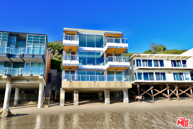 As seen in "Sex & the City." Exclusive beachfront tri-level home on extremely sought-after Malibu Road. Architectural, designed by Jay Vanos. Literally takes your breath away. Glass balconies create a transparent living environment. Entry level recently re-done adding square footage. Contemporary kitchen, top-of-the-line appliances, caesarstone countertops and travertine floors. Exquisite master suite and bath! Spacious entertainment room, wetbar, maids and 2 car garage. Truly sexy and sophisticated! Available Now.