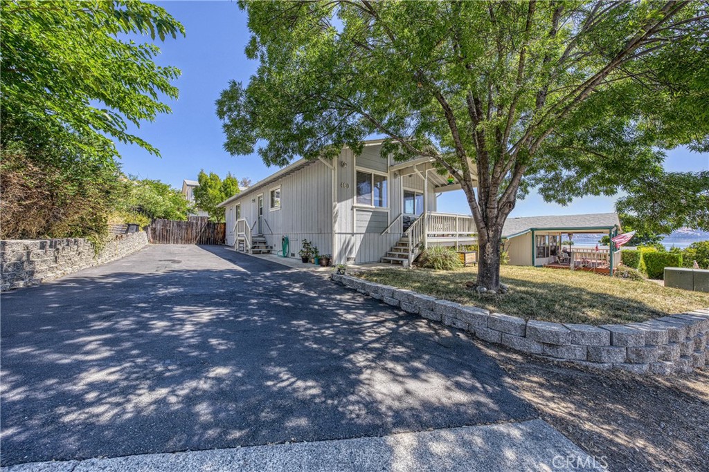 This home offers 2 bedrooms plus an office, all within an open floor plan that provides stunning views of the lake. It's truly a unique opportunity as it's being listed for the first time since it was built in 2005. The sunny front porch is a welcoming feature, perfect for enjoying sunrises, sunsets, and the serene lake scenery. Inside, the open floor plan seamlessly connects the kitchen, which boasts ample countertops, a range, and a dishwasher. For convenience, there's an interior laundry room located just off the side door, adjacent to a long driveway that can accommodate multiple cars or even a boat. The primary bedroom includes an en-suite bathroom, while the second bedroom and office share a hall bath with a tub/shower. The living room, with its views of Clearlake, is accessible from the main entry and covered front deck. Outside, a fenced and flat backyard provides a great space for outdoor activities. This home is ideally located close to the hospital, schools, and shopping, and is only 30 minutes from Ukiah. Additionally, it offers deeded access to a community boat launch, allowing for year-round fishing and water sports on Clearlake.