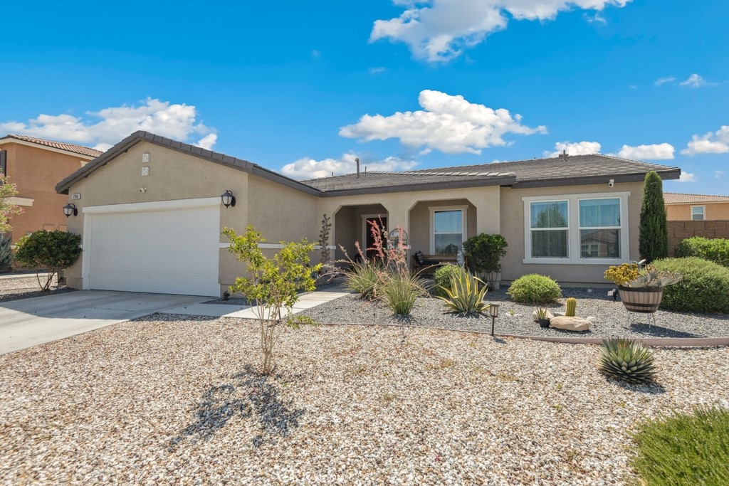 Like new 3 bed, 2 bath home built in 2021 with 1,700 sqft of living space and sitting on a 7,525 sqft lot is ready to be made yours! The exterior offers great curb appeal with drought tolerant landscaping and a covered porch to enjoy! The interior is spacious and open with high ceilings, recessed lights, vinyl plank flooring in the main living areas, carpet floors in the bedrooms, and offers many Smart Home features including Solar Panels, a Smart Thermostat, Smart Doorbell, and an EV Charger in the garage. The great room - with living area and dining area - features large picture windows and a sliding glass door that let in lots of natural light. The gorgeous kitchen offers a breakfast island with quartz counters and seating area for 4! The kitchen also has full tile backsplash, white cabinets, stainless steel appliances and a pantry. There is a laundry room with extra storage space and direct garage access to the 2-Car Garage. All 3 bedrooms are generously sized with the primary suite featuring a private ensuite with dual sink vanity, and there is a full-size hall bathroom for the 2 secondary bedrooms and guests to share. Enjoy the private backyard with block wall fencing, and covered patio that extends the length of the home, this is a great space for entertaining and is ready for the new owner's design. Conveniently located near schools, shopping, dining, and more! Schedule your tour today!