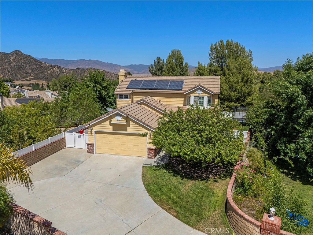 Bravo Bravo! Welcome to Forest Meadow — a stylish, private, and ultra-functional home located in the sought-after Bravo community of Castaic. From the moment you arrive, this property makes an impression. Situated on an entirely usable lot with its own private driveway, RV parking, and room for 6+ cars, this home is designed for space, comfort, and serious curb appeal. Step inside and you’ll find a bright, open-concept layout that blends functionality with modern flair. The entire downstairs features wood-look tile flooring, fresh designer paint, recessed lighting, and updated light fixtures throughout. Natural light pours into every corner, creating a warm and inviting atmosphere from the moment you enter. The kitchen is a showstopper—complete with quartz countertops, a stylish backsplash, plantation shutters, and tons of cabinet space. It’s the perfect setup for everything from weeknight dinners to weekend entertaining. Flowing seamlessly into the living and dining areas, the heart of the home is anchored by a custom quartz fireplace, setting the tone for cozy nights or lively gatherings. The floor plan is ideal for both everyday living and entertaining on a larger scale. Upstairs, retreat to the spacious primary suite—a true haven with vaulted ceilings, panoramic views from every window, a private den/flex space (ideal for a home office, nursery, or workout nook), and a charming sitting area perfect for morning coffee or a peaceful reading corner. The en-suite bath features dual sinks, a walk-in closet, and spa-like finishes. Step outside and enjoy your very own entertainment-style backyard. Designed for maximum privacy and low maintenance, it features artificial turf, a covered patio, vinyl fencing, a succulent garden, and fresh landscaping throughout. Take in breathtaking mountain and lake views while hosting friends or enjoying a quiet evening under the stars. Other highlights include: Solar panels for low monthly energy bills, PEX plumbing, Security system ready for takeover, Extra-padded carpeting upstairs for added comfort, Direct access to schools, parks, lakes, and freeway connections. This home is the total package—modern, move-in ready, and packed with upgrades, all in one of the best pockets of Castaic. Whether you’re looking for space to grow or a private retreat with easy access to it all, Forest Meadow delivers. Don’t miss your chance to call this Bravo beauty home. Showings available now!