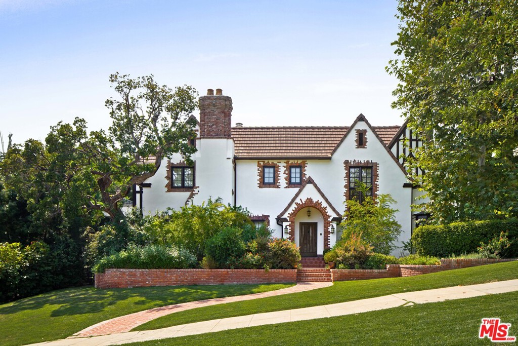 A true Los Feliz Trophy Estate on an oversized lot. Behind the impressive English facade this grand house has undergone a meticulous multi-million dollar renovation. Arranged over 3 floors, this family home is perfect for today's lifestyle. The public rooms are large and bright with original details and include a massive living room with original paneling, window seats, and wood burning fireplace. There is an oversized formal dinning room adjacent to a bright and open kitchen and family room. Upstairs, the primary bedroom has two large walk-in closets, an enormous bathroom, as well as a private terrace with city views. There are two additional bedrooms upstairs, each with en-suite baths. Additional rooms include, screening room, den, cafe, and guest house. The expansive lot includes a large pool with swimming lane, flat grassy yard, and outdoor kitchen. Gated for maximum privacy, there is ample parking and a 3 bay garage. Truly the finest Los Feliz Estate to be available in years.