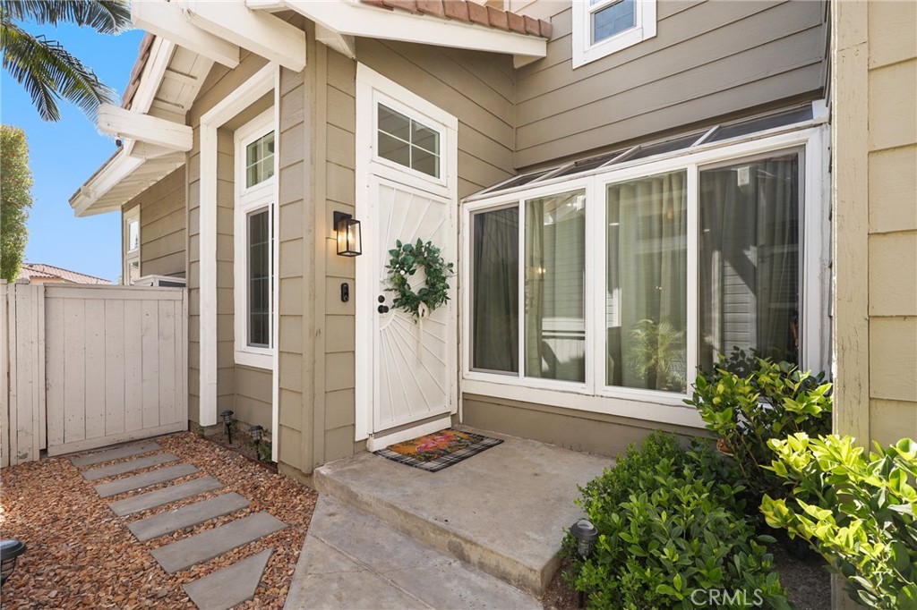 Enjoy the perfect combination of comfort, privacy, and modern finishes in this upgraded 3-bedroom, 2.5-bath townhome in the highly desirable Sycamore Glen community of Tustin Ranch, served by an award-winning school district. Offering 1,610 sq. ft. of thoughtfully designed living space plus a two-car attached garage, this home lives like a detached residence, with only one partially shared wall and one of the largest, private backyards in the neighborhood. From the moment you enter, you’ll notice the quality craftsmanship and stylish finishes that make this property truly move-in ready. The 2022 kitchen remodel is a chef’s dream, featuring elegant quartz countertops, a designer backsplash, modern cabinetry with soft-close doors, stylish hardware, and updated appliances. All bathrooms have been tastefully renovated with spa-inspired showers, dual vanities, quartz counters, and premium finishes. The home boasts new luxury vinyl plank flooring, tall baseboards, and custom shades for a clean, modern look. Additional upgrades include double-pane windows and sliding doors (2023), smart fans and lights in all bedrooms, Nest thermostat, epoxy-coated garage floor, built-in garage cabinets, whole-house water filtration, and a reverse osmosis drinking water system. The backyard—beautifully landscaped with turf and accessible from both the living room and gated side entry—offers a perfect space for entertaining, gardening, or simply relaxing. Ideally located close to parks, golf courses, shopping, dining, and top-rated schools, this turnkey home provides a rare combination of style, comfort, and convenience in one of Orange County’s most sought-after neighborhoods. Whether hosting guests, working from your built-in office space, or enjoying quiet evenings in your private yard, this home is designed to fit your lifestyle perfectly.