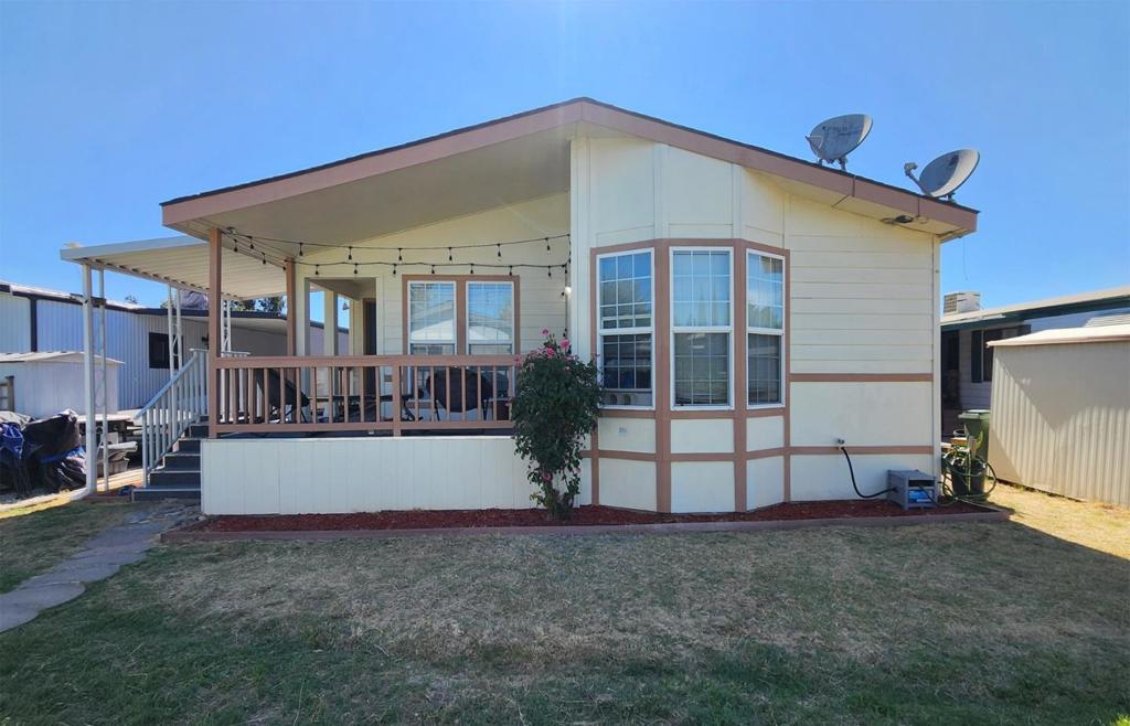 This charming property offers 1,734 square feet of living space with 3 bedrooms and 2 full bathrooms. Spacious living room features cathedral ceiling, cozy fireplace, built-in wall shelves, and laminated floor throughout the entire home. Living room, kitchen, and bedrooms have recess lights. The kitchen is highlighted with granite countertop, large center island for bar seating and stainless steel appliances. A separate bonus room can be used as an office or perfect as a guest room. Large master bedroom includes 2 walk-in closets and a bathroom that includes a huge soaking tub and a walk-in shower. Laundry room offers a washer and dryer with additional storage cabinets. This home is equipped with air conditioning and central heating for your comfort. Park amenities include a club house, community pool, billiard room, and exercise gym. It is perfectly located near restaurants, shopping, and easy freeway access. Low monthly space rent of only $1,116. Don't miss the chance to make this your new home.