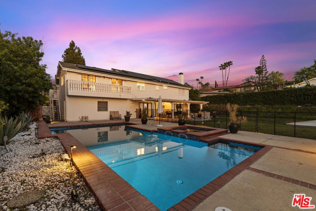 Now available for lease, 4815 Adele is an exceptional six bedroom, four bath residence south of Ventura in one of Woodland Hills' most sought after pockets. Recently remodeled, the home showcases new hardwood floors, LED lighting, and timeless upgrades such as quartz countertops and stainless steel appliances. An open-concept kitchen and living room flow seamlessly to the expansive backyard through wall-to-wall sliders, creating an inviting setting for everyday living and effortless entertaining. The first floor includes a versatile guest room with an ensuite bath that also serves as a convenient powder room. Upstairs are four spacious bedrooms one currently used as a home office while the primary suite features an oversized walk-in closet, an updated bath, and twin sets of French doors opening to a balcony with treetop views. A sixth bedroom, set apart off the epoxy finished garage, enjoys its own private bath and entrance, perfect for guests or a separate workspace. Set on nearly half an acre, the grounds offer a pool and spa, large sports court, pergola shaded lounge, and generous flat entertaining areas, all framing sweeping vistas. Woodland Hills residents appreciate top rated schools, abundant dining and retail at The Village and Westfield Topanga, quick access to Santa Monica Mountain trails, and an easy 101 Freeway commute. A solar system adds sustainability and savings capturing the best of Southern California living.