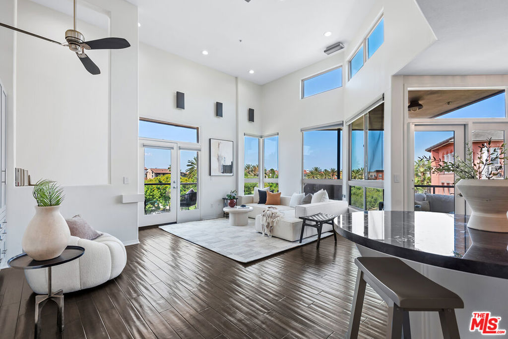 Flooded with natural light, this stunning two-story corner penthouse is located in the highly desirable Promenade building, offering dramatic views of Concert Park. Featuring 2 spacious bedrooms and 2.5 bathrooms, this sophisticated residence boasts a dramatic living room with soaring 14-foot ceilings, expansive windows, recessed and accent lighting, surround sound speakers upstairs, and beautiful engineered wood floors. The open-concept chef's kitchen is equipped with stainless steel appliances, granite countertops, a breakfast bar, and an adjacent dining area making this home perfect for entertaining. Two private balconies provide ideal spots for enjoying park and sunset views. Downstairs, the primary suite showcases an en-suite spa-like bathroom with a dual vanity, separate shower and tub, and a Bluetooth speaker. Thoughtful custom built-ins add style and functionality throughout the home. Additional features include in-unit laundry, each floor has its own dedicated HVAC system., and two separate parking spaces offering an EV charger in one of the spaces. As a resident, you'll have access to the Centerpointe Club, which features a fully-equipped gym, a sparkling pool, a relaxing spa, a private screening room, a business center and conference rooms, The Resort fitness center and pool, and nearby, the Runway at Playa Vista offers even more conveniences, including a Cinemark Movie Theater, Whole Foods, a farmer's market, additional dining options, shopping, tennis courts, pickleball courts, three dog parks, and more.**Buyer to pay Playa Vista Community Enhancement Fee (3/4 of 1%). ***Phase 1 of Playa Vista is a Mello-Roos community. ***Buyers to satisfy themselves on amount and length of bond.****Buyers are advised to independently verify accuracy of all information through professional inspection with appropriate professionals***Broker/Agent does not guarantee accuracy of square footage, lot size, zoning, rent control, permits, use code, schools and/or other information concerning the conditions or features of the property provided by the seller or obtained from public records or other sources.***