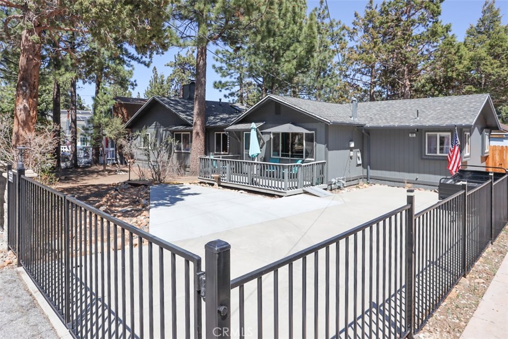 Discover your serene retreat in this inviting property, ideally nestled just 2 blocks from the national forest in a peaceful neighborhood. Sitting on a generously sized 8,800 sq ft fully fenced lot, this home is a rare find with plenty of thoughtful upgrades. The newer front block and railing fence and gates offer added privacy, while the west-facing front deck welcomes you to bask in the sunshine. Step through French doors onto the expansive east-facing rear deck, partially covered to ensure you can enjoy it rain or shine. Inside, you'll be greeted by upgraded dual-pane windows that brighten the space, two full bathrooms, and newer appliances in the kitchen, wonderful for convenience and comfort. This charming home also features a unique double-sided wall-to-ceiling fireplace, connecting the cozy living room and the master bedroom. A potbelly stove in the den adds a rustic touch, complemented by 3 efficient wall heaters for year-round comfort. You'll enjoy the 2 large bedrooms, plus a cozy den/family room between the bedrooms. With a freshly painted interior and exterior, new rain gutters, and two water heaters, this property is truly move-in ready. The lot offers ample parking for 3-4 cars and even includes an aesthetically pleasing storage container to accommodate your storage needs. The home is being sold unfurnished, inviting you to create your dream living space. Embrace the tranquility and charm of this exceptional home. Effective age: 1999