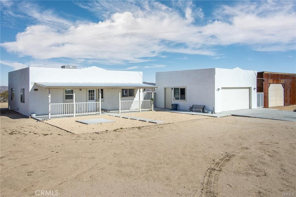 **SEE VIDEO ABOVE!** Immaculately maintained and in near-perfect condition, this Southwest-style adobe home features a detached garage that can be converted into a permitted guest house or Accessory Dwelling Unit (ADU). Additionally, there is a beautifully constructed metal workshop, ideal for an artist's studio retreat. The large parcel offers ample space for privacy and easy access to Reche Rd via Fortuna Ave. Enjoy great views of the iconic Goat Mountain.VIEWS VIEWS VIEWS!
Conveniently located a few miles from a coffee shop, gourmet restaurant, grocery store, café, and gas station at Hero's Market, there's no need to drive to Yucca Valley for supplies. This property is situated in an ideal location for short-term rentals,long term rental, offering remote privacy with the conveniences of town. There are no restrictions on permitting for Airbnb.This unique opportunity is perfect as a primary residence, a vacation getaway, or an excellent short-term rental. There are currently no rental restrictions set by the local municipality, making this an ideal investment to supplement your expenses. Don't let this incredible opportunity pass you by!
The Integatron and Giant Rock are just up the road, making this a fantastic, well-kept property in the heart of Landers. The sellers are motivated and open to offers! This beautiful home is situated high on the mesa, boasting fantastic views. The contractor has gone the extra mile with 2x6 construction, 16" on center, R38 in the ceiling, R19 in the walls, and sheared walls throughout. The patios are set up for covers, the garage door is insulated, and it is even plumbed for an outdoor shower.
Inside, you'll find a spacious kitchen with ceramic tile countertops, stainless steel appliances—including a side-by-side refrigerator—a breakfast bar, and ample cupboard space. The custom vertical blinds add a nice touch. The bedrooms are simple yet functional, featuring ceiling fans and mirrored closet doors. Additionally, cable, internet, and phone services are available.
The roomy bathroom is practical, and the home has central heating and air conditioning. Large concrete patios and connecting walkways enhance the outdoor space. The finished and painted garage features an automatic door opener, two large windows for light and ventilation, laundry hook-ups, and motion sensor security lights.
This is truly a must-see—don’t wait, call now.