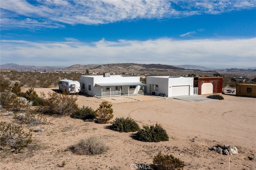 **SEE VIDEO ABOVE!** Immaculately maintained and in near-perfect condition, this Southwest-style adobe home features a detached garage that can be converted into a permitted guest house or Accessory Dwelling Unit (ADU). Additionally, there is a beautifully constructed metal workshop, ideal for an artist's studio retreat. The large parcel offers ample space for privacy and easy access to Reche Rd via Fortuna Ave. Enjoy great views of the iconic Goat Mountain.VIEWS VIEWS VIEWS!



Conveniently located a few miles from a coffee shop, gourmet restaurant, grocery store, café, and gas station at Hero's Market, there's no need to drive to Yucca Valley for supplies. This property is situated in an ideal location for short-term rentals,long term rental, offering remote privacy with the conveniences of town. There are no restrictions on permitting for Airbnb.This unique opportunity is perfect as a primary residence, a vacation getaway, or an excellent short-term rental. There are currently no rental restrictions set by the local municipality, making this an ideal investment to supplement your expenses. Don't let this incredible opportunity pass you by!



The Integatron and Giant Rock are just up the road, making this a fantastic, well-kept property in the heart of Landers. The sellers are motivated and open to offers! This beautiful home is situated high on the mesa, boasting fantastic views. The contractor has gone the extra mile with 2x6 construction, 16" on center, R38 in the ceiling, R19 in the walls, and sheared walls throughout. The patios are set up for covers, the garage door is insulated, and it is even plumbed for an outdoor shower.



Inside, you'll find a spacious kitchen with ceramic tile countertops, stainless steel appliances—including a side-by-side refrigerator—a breakfast bar, and ample cupboard space. The custom vertical blinds add a nice touch. The bedrooms are simple yet functional, featuring ceiling fans and mirrored closet doors. Additionally, cable, internet, and phone services are available.



The roomy bathroom is practical, and the home has central heating and air conditioning. Large concrete patios and connecting walkways enhance the outdoor space. The finished and painted garage features an automatic door opener, two large windows for light and ventilation, laundry hook-ups, and motion sensor security lights.



This is truly a must-see—don’t wait, call now.