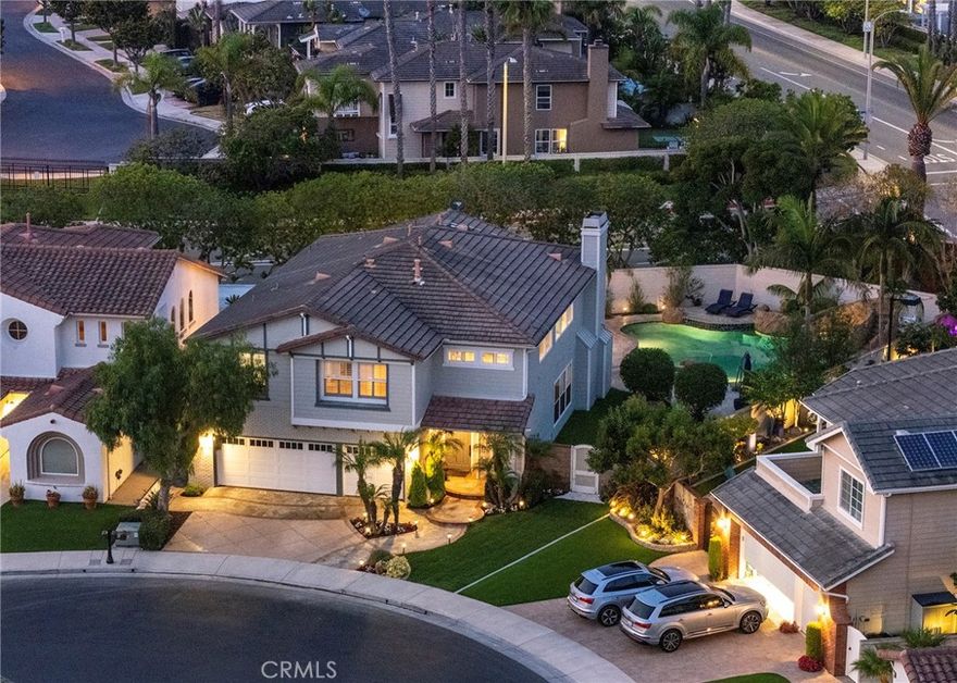 Tucked away on an oversized lot in one of Huntington Beach’s most coveted 24 hour guard - gated communities, The Peninsula, this richly upgraded home offers unmatched comfort, privacy, and sophistication. Thoughtfully expanded and meticulously designed, the residence welcomes you with grand high ceilings adorned with dazzling crystal chandeliers, soaring windows, and lush landscaping that frames the serene setting.

The custom chef’s kitchen is a true showpiece—featuring high-end Thermador appliances including a gas range and triple ovens, multiple beverage refrigerators, exquisite millwork, and luxurious stone countertops. The open-concept family room is finished with wood beams, venetian plaster, built-in surround sound, a stone fireplace, and sliding glass doors that lead effortlessly to your private outdoor paradise—perfect for entertaining.

The main floor also includes a spacious walk-in pantry, stylish powder room, and a versatile office or guest suite with its own full bath. Upstairs, discover two well-appointed guest bedrooms, a full bathroom, laundry room, office area, and a bonus room. The expanded primary suite offers a retreat-like experience with a private balcony overlooking the backyard, a spa-inspired bathroom with dual sinks, walk-in shower, jacuzzi tub, and a walk-in closet. Step outside into a resort-style oasis: covered outdoor kitchen with built-in BBQ, stove, counter seating, fireplace, pool and spa, waterslide, multiple firepits, and grassy areas ideal for play or pets. Located just moments from award-winning Seacliff Elementary School, serene beaches, local parks, the ecological reserve, and all the best of coastal living—this is a rare opportunity to own a dream home in an unbeatable location.