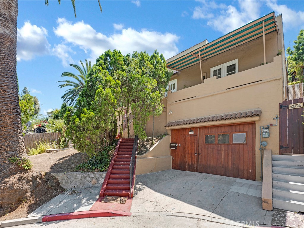 Tucked away in a peaceful cul-de-sac in the heart of iconic Beachwood Canyon, this enchanting residence offers the perfect blend of tranquility, charm, and convenience. Just moments from beloved local markets, cozy cafes, and scenic hiking trails, the location provides a coveted canyon lifestyle while staying close to everything you need. Step inside to beautiful living room featuring grand picture windows, a decorative fireplace, and a seamless flow into the dining area and generously sized kitchen—ideal for entertaining or intimate meals. The kitchen is beautifully updated with granite countertops, crisp white cabinetry, and stainless steel appliances, catering to both seasoned chefs and casual cooks alike. The primary bedroom offers a serene connection to the outdoors, with a door opening to a private patio area—perfect for enjoying morning coffee, afternoon breezes, or a quiet evening under the stars. A second bedroom offers versatility, ideal as a guest room, home office, or creative studio. The updated bathroom is thoughtfully designed with a custom-tiled tub/shower combo and a modern vanity, blending comfort and style. Throughout the home, you’ll find a tasteful mix of timeless character and contemporary updates, providing the perfect canvas for your personal touch. Outside, the spacious areas around the home awaits your creative ideas and designs, inviting you to relax, garden, or host al fresco gatherings in your own peaceful oasis. This welcoming street is cherished by locals and has even attracted well-known Hollywood figures who value its quiet charm and community feel. Experience the best of canyon living—peaceful, picturesque, and just minutes from the vibrancy of the city. This is more than a home; it’s a lifestyle.