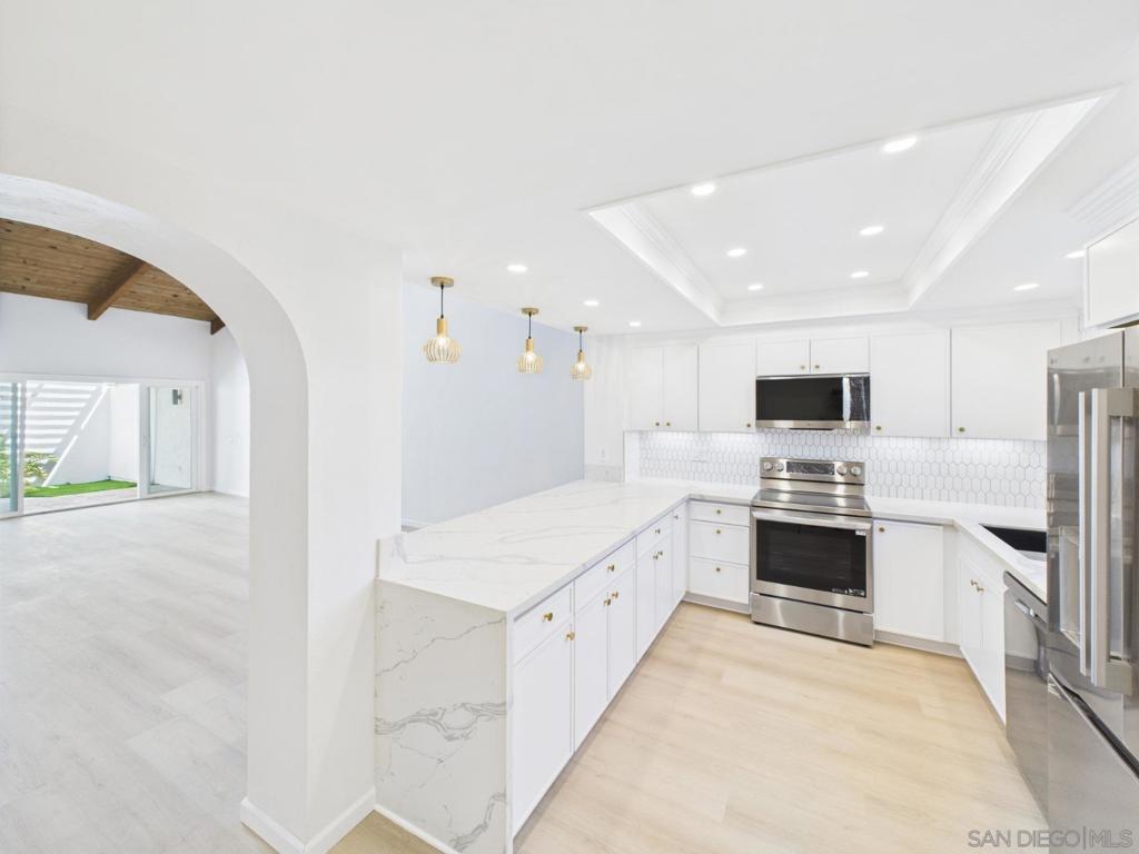 Elegant Single-Story Retreat in Bel Air Vista – Fully Remodeled Luxury Living Beautifully remodeled single-story home in exclusive Bel Air Vista! This 2BR/2BA townhome features vaulted ceilings, a skylight, and an open-concept layout with SPC flooring throughout. The gourmet kitchen boasts quartz waterfall countertops, picket backsplash, stainless appliances, and a coffered ceiling with recessed lights. The spacious living room showcases a dramatic black tile fireplace with shiplap surround and patio access. Both bathrooms are fully upgraded with walk-in rain showers, designer tile, and matte black fixtures. The primary suite offers vaulted ceilings and a spa-style bath with bench seat and mosaic niche. Enjoy a private courtyard, attic storage access, detached 2-car garage, dual-pane windows, fresh paint, and newer systems. Community amenities include a pool, spa, clubhouse, and lush landscaping. HOA covers water, trash, roof, and exterior. Prime location near shops, restaurants, parks, and just 15 mins to the beach! Elegant Single-Story Retreat in Bel Air Vista – Fully Remodeled Luxury Living Beautifully remodeled single-story home in exclusive Bel Air Vista! This 2BR/2BA townhome features vaulted ceilings, a skylight, and an open-concept layout with SPC flooring throughout. The gourmet kitchen boasts quartz waterfall countertops, picket backsplash, stainless appliances, and a coffered ceiling with recessed lights. The spacious living room showcases a dramatic black tile fireplace with shiplap surround and patio access. Both bathrooms are fully upgraded with walk-in rain showers, designer tile, and matte black fixtures. The primary suite offers vaulted ceilings and a spa-style bath with bench seat and mosaic niche. Enjoy a private courtyard, attic storage access, detached 2-car garage, dual-pane windows, fresh paint, and newer systems. Community amenities include a pool, spa, clubhouse, and lush landscaping. HOA covers water, trash, roof, and exterior. Prime location near shops, restaurants, parks and the beach!