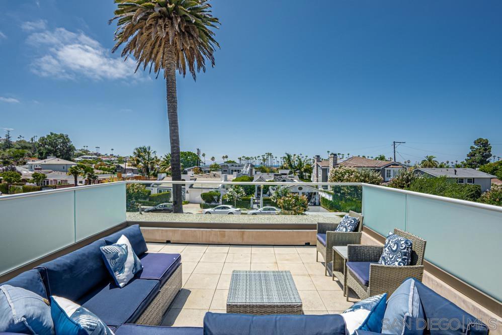 Just moments from the sand, this single-level retreat offers a spacious open floor plan, lush outdoor spaces, and ocean views from the rooftop deck. Step through the gated front yard and into the home's interior. Directly ahead, a beautifully styled dining area seats four. The fully equipped kitchen features modern appliances and a large island with bar seating for three. To the left, the first of two living areas welcomes you with a plush sofa, TV, and additional seating for lounging or connecting with friends and family. A second living space offers a queen pull-out sofa, cozy fireplace, a second TV, and extra seating. Oversized sliding glass doors span the rear of the home, opening wide to reveal a private backyard retreat surrounded by greenery. Enjoy a second outdoor table for four, lounge chairs, fire pit, and an outdoor TV adding to the entertainment options. From the backyard, a staircase leads to the rooftop deck where you'll find cushioned lounge seating and panoramic ocean views of La Jolla Shores. Inside, the home features three beautifully appointed bedrooms. The primary suite offers a king bed, walk-in closet, private TV, and a spa-like bathroom. Two guest bedrooms, each with a queen bed, share a stylish full bathroom, and there’s an additional half bath for convenience. Parking includes a garage space for two vehicles and driveway access. This home features central air conditioning, in-unit laundry, no pets allowed. Sleeping Accommodations (Max Occupancy 8): Bedroom 1- 1 King bed Bedroom 2- 1 Queen bed Bedroom 3- 1 Queen bed Shared Space- 1 Queen Sofa Bed. • 30-night minimum stay • No pets allowed • No Smoking • Guests ages 25+ unless family groups • Parking: 2 garage parking spots/driveway access, and street parking available for guests • Events/parties are not permitted and strictly enforced • Pack n' play and high chair available for rent - $25 each plus tax • As part of our standard verification process, we kindly request that the guest signs an additional agreement and verifies ID. Your comfort and security are important to us. As part of our personalized guest experience, a Guest Experience Manager will personally welcome you at your preferred arrival time. They’ll provide a guided walkthrough, ensuring you're familiar with the home's amenities so you can settle in effortlessly and start enjoying your vacation right away. From answering questions to offering local recommendations, we’re here to make your stay seamless and unforgettable.