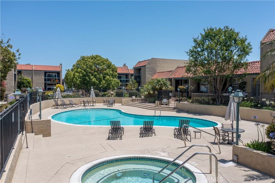 Welcome to 958 Palo Verde, a stunning tri-level condo located in the exclusive guard-gated community of Bixby Hill. Residents enjoy resort-style amenities including a sparkling pool and spa, tennis courts, fitness center, lounge area, and a clubhouse for entertaining.



This expansive home offers over 2,100 square feet of elegant living space. The main level opens to a dramatic living room with soaring ceilings and a striking fireplace, alongside a formal dining area and a recently remodeled kitchen featuring rich cabinetry, natural stone counters, and a full suite of appliances including stove, dishwasher, microwave, and refrigerator. A charming breakfast nook completes this level.



Upstairs, you’ll find two spacious bedrooms, including a luxurious master suite with dual walk-in closets and a spa-like ensuite bath with a jetted tub. A guest bedroom and adjacent full bath complete the upper level.



The lower level features a versatile flex room, ideal as a third bedroom, den, study, or game room. Additional highlights include a private two-car attached garage, in-unit laundry with washer and dryer, and central heating and air conditioning.



Experience refined living in one of Long Beach’s most sought-after communities—where comfort, security, and lifestyle amenities meet.