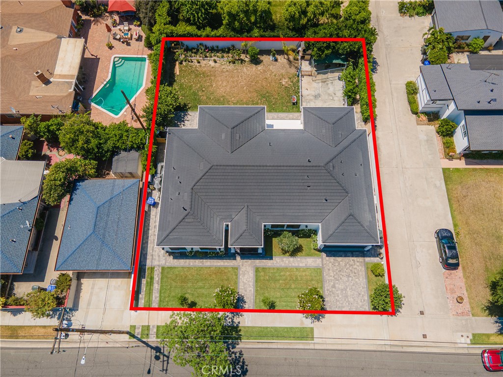 Welcome to this one-of-a-kind, newly built luxury estate nestled in one of Downey's most desirable neighborhoods. Boasting 3,905 square feet of brand-new construction on an oversized 11,353 square foot lot, this exceptional 5-bedroom, 3-bathroom residence offers the perfect blend of timeless elegance and modern design. Every inch of this home was thoughtfully reimagined and constructed from the ground up with no expense spared. Step through grand custom double doors into a light-filled open floor plan featuring dramatic vaulted wood ceilings, oversized porcelain tile flooring, and exquisite LED mood lighting throughout. The designer kitchen is a true showpiece, highlighted by a massive waterfall island wrapped in rich marble, a built-in gas cooktop, custom white cabinetry, double ovens, and a separate coffee bar. Enjoy the convenience of a full bar area with built-in shelving and wine display, ideal for entertaining in style. The elegant dining area flows seamlessly into the spacious living room, complete with a custom black media wall, integrated fireplace, and built-in shelving. Expansive windows and glass doors create the perfect indoor-outdoor experience, leading to the covered patio with custom ceiling design and views of the oversized backyard ready for your dream pool or garden oasis. The home offers five generously sized bedrooms and three spa-like bathrooms featuring floor-to-ceiling marble finishes, walk-in showers with custom stone tile flooring, and luxury vanities. Additional highlights include: • Gated private driveway • Custom iron double entry doors • Designer lighting and fixtures • Oversized laundry/mud room • Two-car garage with modern glass doors • Fully landscaped front yard and spacious backyard with endless potential
This rare gem offers luxury, space, and architectural beauty in one of the most sought-after communities in Downey. A must-see property for the most discerning buyer.