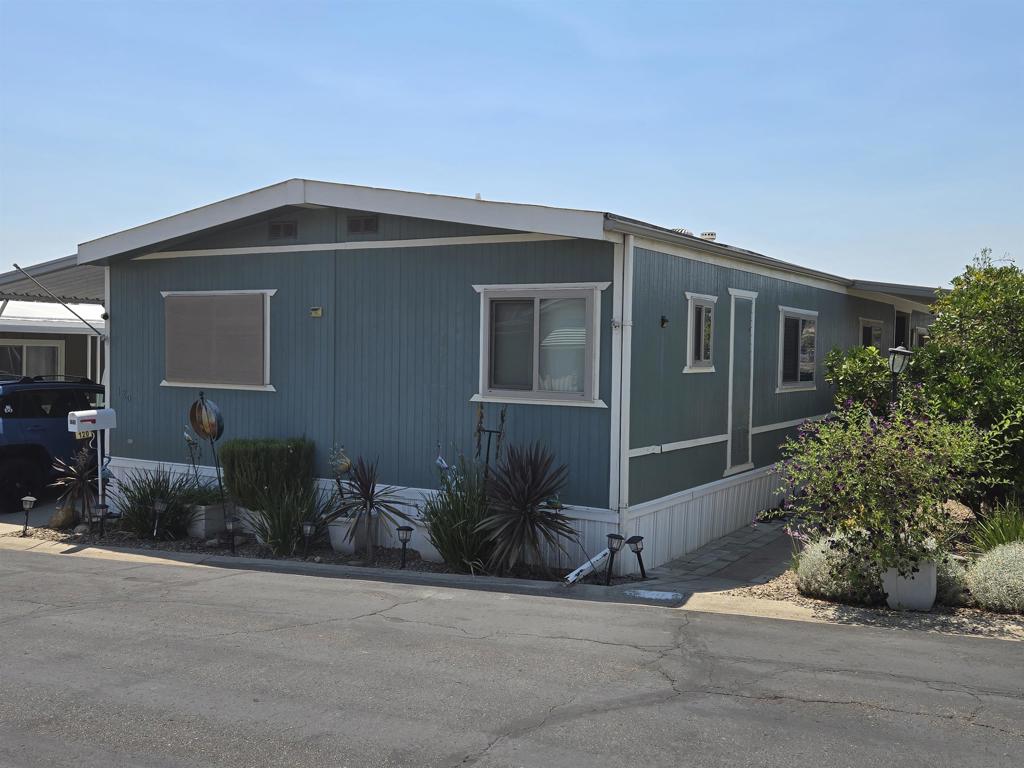 Welcome to this beautiful upgraded home located in the 55+ community of Terrace Estates, offering serene views and a welcoming neighborhood atmosphere. Park amenities include a community pool, clubhouse, and dog park. This spacious home features an open floorplan with stylish laminate wood flooring throughout. The upgraded kitchen is complete with a 6-burner stove, upgraded countertops, and an under-sink instant hot water heater. Additional upgrades include a whole-house water filtration system, central A/C, and a newer LG washer and dryer set.