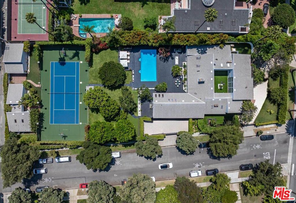 Welcome to an ultra rare jewel in the Flat of Beverly Hills a sprawling little shy of one acre (40,478 sq. ft.), fully gated estate featuring a single level, 7,000 sq. ft. residence, offered for the first time in more than three decades. Designed to evoke a true resort style lifestyle, this masterfully remodeled property boasts a heated saltwater pool, private tennis and basketball courts, a full gym, and a state-of-the-art surround sound system, creating an unparalleled environment for relaxation and entertainment. The estate is thoughtfully appointed with five bedrooms in the main residence and two additional bedrooms in the private guest house, blending comfort with sophistication for family and guests alike. A chef's kitchen with professional grade appliances anchors the home, while expansive living areas flow seamlessly to lush, manicured grounds ideal for hosting gatherings or enjoying tranquil privacy. Fully furnished with high-end Italian designer pieces, with flexibility to customize selections, the interiors reflect refined luxury tailored to your lifestyle. Security and peace of mind are assured with complete perimeter cameras, gated entry, and parking for 10+ cars. Available exclusively for luxury rental beginning January 15, the estate also embraces modern flexibility with the option to pay in cryptocurrency, making this one-of-a-kind Beverly Hills retreat as forward thinking as it is timeless.