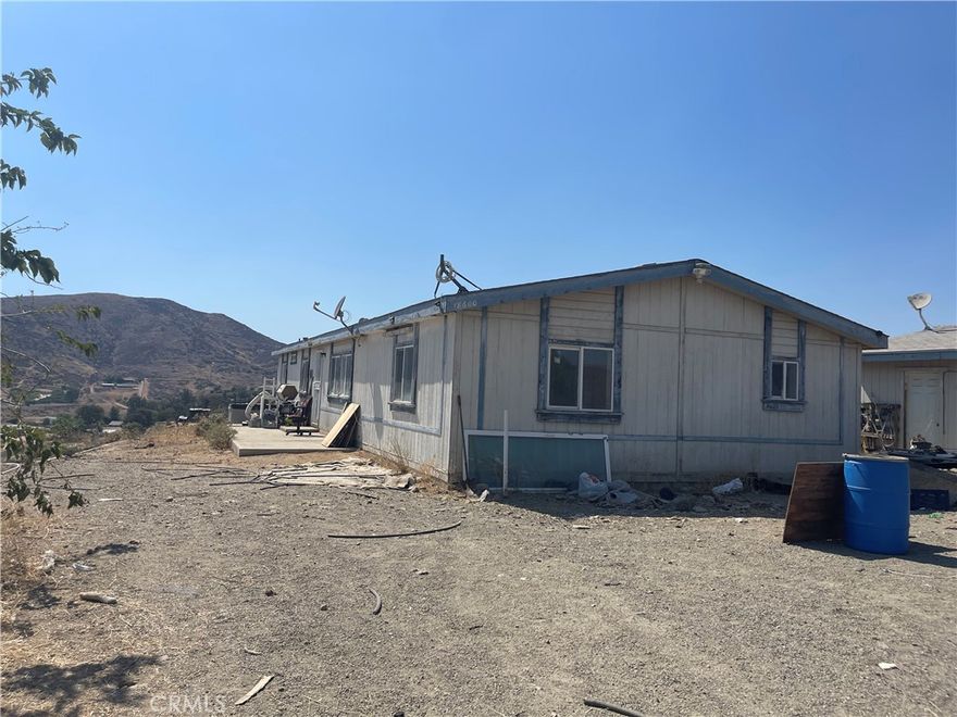 Great opportunity for a 4.69 Acres, Manufactured home on Hilltop with Views! 
Manufactured home with 4 bedrooms, 2 baths, horse property and 1,716 sq. ft. situated on 4.69 acres (approximately 2.5 acres fenced). Property sits atop a hill with sweeping lake and city views. Includes a spacious detached 2-car garage with a 7' door and plenty of room to add a workshop area. All utilities are connected. Property offers lots of potential, including room for pets to roam.  Just 1.5 miles to the freeway and outlet mall—great location, priced to sell! Home needs some TLC but is priced to sell. Property will be sold as-is. Great fixer opportunity.  Buyer and buyer’s agent to verify all details to satisfy themselves.