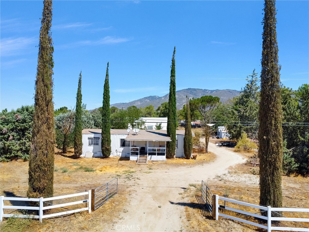 Charming country living awaits in Anza! This spacious manufactured home features 2 bedrooms (currently set up as 3, with the extra room perfect for an office or bedroom) and 2 baths, offering approximately 1,344 sq ft of comfortable living space. Situated on a fully usable 1-acre lot, the property includes a livable barn with a loft and 1½ baths—ideal for hobbies, guests, or extra space. Inside, you’ll find a practical layout with generously sized rooms ready for your personal touch. The fenced yard boasts mature trees, open lawns, and plenty of room for animals or outdoor activities. Located on a paved road, this home provides the perfect balance of rural peace and convenient access. Whether you’re seeking a full-time residence, a weekend retreat, or a property with endless potential, this serene setting is ready to welcome you home.