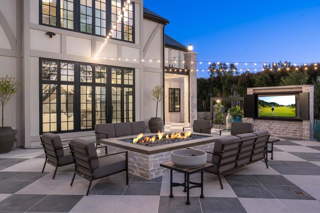 This Impeccable Custom Estate feels more like New Construction and is an Entertainers Dream! Current Sellers just rebuilt all bedroom suite bathrooms and made additional and incredible enhancements, which included adding more outdoor living, enhanced landscape plus adding a jacuzzi to the salt water resort pool. The location is A++ with a full SOLAR Tesla roof, all new doors and windows throughout, custom steel front door, oversized fire pit and 2 large outdoor TVs, great BBQ area, designer kitchen w/top end appliances. The Primary suite is oversized with sep Her & His custom closets that will have any the fussiest happy and the NEW Spa Bath takes luxury to a new level. The office has a separate entrance for those who work from home and the game room is the best place to hang with custom waterfall wet bar with wine storage, champagne area plus ice maker. The property offers a main floor guest wing and there is lots of room to add an ADU "guest home" if desired. The sense of arrival from the street is impressive with a long driveway leading guests up to the walk way.