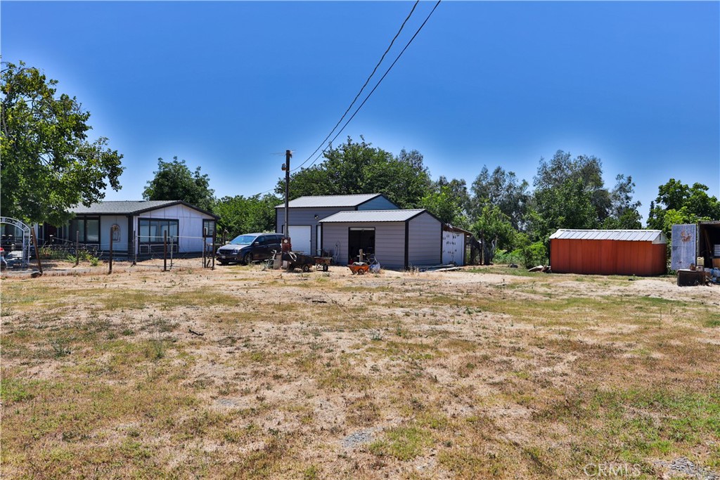 A GREAT opportunity. Welcome to 22319 O Avenue in Corning. Conveniently located near shopping , dinning and schools. This beautiful home is situated minutes from downtown Corning on a generous 2.11 acre lot in a very quiet established neighborhood. If you are looking for a spacious home, This Is It. Featuring 3 bedrooms, 2 bathrooms, a MAN CAVE and a spacious craft room. The open kitchen is perfect for cooking and baking. Walk out to a spacious wood deck on the south side of the house overlooking the walnut orchard. Don't forget about the 75 plus walnut trees, Chandler and Robert Livermore Red Meat variety that make this place a Hobby/Family farm. With plenty of mature fruit bearing trees, the list is endless. Pomegranates, almond, 3 plum, 2 pecan, peach, nectarine, apple, Asian pear, fig, apricot, orange, and lemon. Also thornless blackberry and grapes. With 3 fruitless mulberry trees for extra shade and an established Wysteria vine that adds a beautiful view of the pond area. A row of mature Eucalyptus trees are in a perfect spot that determine the boundary lines. The front yard has lushes green grass and plenty of trees that provide shade during the hot summers. Two car detached garage can also be used as a shop. A storage garage that is 12x20 is perfect place to store the walnut harvest. Also a She Shed measuring 10x20 can be turned into your personal space. Included is a 50 foot container to hold all the farm equipment. This is more than just a home, its a peaceful retreat from the city and traffic. This property is part of the Corning Water District. Call for a showing Today.
