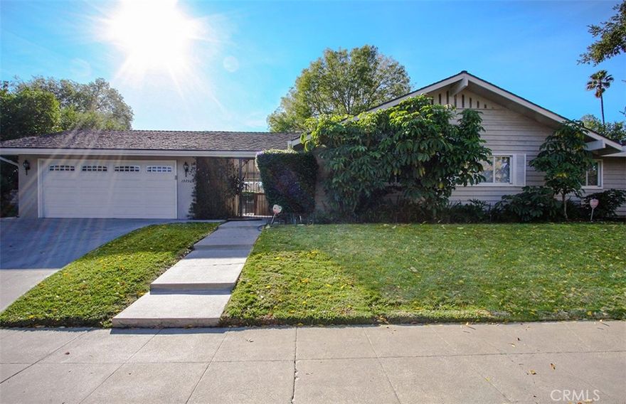 Beautiful single-level home located South of the Boulevard, set on a sweeping corner lot with a gated courtyard entry and circular driveway. Inside, hardwood floors flow throughout the spacious floorplan, which includes four bedrooms, a family room, living room, dining room, and abundant closet space. The updated kitchen boasts quartz countertops, stainless steel appliances, and a cozy breakfast area. Bathrooms are thoughtfully designed with frameless glass shower enclosures, dual sinks in primary and full bathroom, quartz counters, and sleek modern fixtures.

Additional features include new dual-pane windows, an in-house laundry with a versatile quartz counter/dry bar, and a double-car garage. The expansive outdoor spaces are ideal for entertaining, with a recently renovated pool area and a separate backyard.