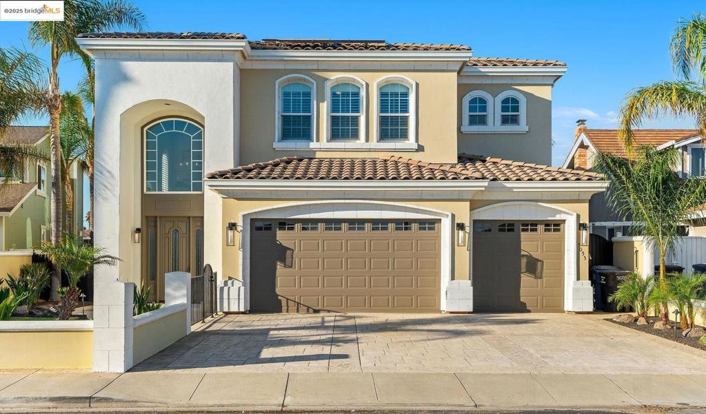 Nestled on a wide, serene bay, this spectacular Discovery Bay home offers unparalleled waterfront living! Gorgeous staircase and custom lighting give a captivating first impression! The spacious, airy great room provides formal dining, along with island seating for entertaining! Large windows maximize views whether you are enjoying the chef's kitchen or seated around the fireplace. The meticulously crafted kitchen offers comfort, sophistication & ease! Walk-in pantry, deep sink, wide Viking stovetop- attention to detail is evident throughout. Custom bar overlooks the water and sliders lead to expansive deck & dock, melding the indoors with outdoor living. Covered deck has a kitchen + a seating area that overlooks double U dock with sparkling pool. One ensuite bedroom on main floor, or use the elevator to reach 4 more ensuite bedrooms. The primary suite is a true retreat, providing lavish amenities like delta views from the balcony, a seating or office area, fireplace, wet bar & wine fridge. Spa-like bath completes this luxury space w/deep, jetted tub + walk-in closet outfitted with beautiful built-ins. The three car garage boasts LOADS of storage w/ cabinets & extended space. Owned solar provides monthly savings, making this luxury estate smart, as well as beautiful! See it soon!