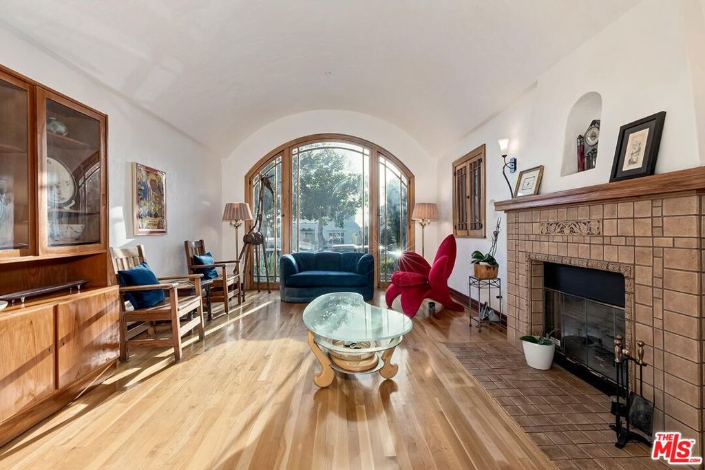 Tucked away on a quiet, tree-lined street north of Montana Avenue, and even north of Carlyle, lies a rare Spanish Revival home that tells a story nearly a century in the making. Originally built in 1926, this residence is more than a home it's a work of art lovingly brought back to life. In 2014, it underwent a meticulous restoration, not just to preserve its historic soul, but to prepare it for the century ahead. Every decision was made with care: steel reinforcements and foundational upgrades allow the home to stand strong against earthquakes up to 7.6 in magnitude, while eco-conscious features like a water return system protect the land it rests on. Step inside and you're transported. Light pours into the dramatic living room through original 1926 windows, arching toward a soaring barrel-vaulted ceiling. Oak hardwood floors carry you from room to room, whispering stories of the past. The kitchens and baths are finished in elegant Carrara marble, with fixtures and materials chosen to reflect the colors, textures, and techniques of the home's original era. But this is no relic. Every system - electrical, plumbing, sewer - was rebuilt with modern standards in mind, including buried electrical lines, fiber optic internet, two tankless water heaters, and zoned HVAC (three in the main house, two in the guesthouse). The integrity of the past meets the innovation of today. The main residence spans approximately 2,851 square feet with four bedrooms and three baths. A separate, beautifully designed two-story guesthouse offers 738 square feet with one bedroom, one and a half baths, a full kitchen and living area, and a generous 18.5' x 18' garage. As the home approaches its 100th birthday in 2026, it stands stronger and more stunning than ever - a perfect blend of heritage and forward-thinking design. This is a place where the beauty of the past meets the promise of the future. A home built not just to admire, but to live in, to grow in, and to treasure for generations to come.