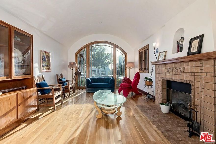 Tucked away on a quiet, tree-lined street north of Montana Avenue, and even north of Carlyle, lies a rare Spanish Revival home that tells a story nearly a century in the making. Originally built in 1926, this residence is more than a home  it's a work of art lovingly brought back to life. In 2014, it underwent a meticulous restoration, not just to preserve its historic soul, but to prepare it for the century ahead. Every decision was made with care: steel reinforcements and foundational upgrades allow the home to stand strong against earthquakes up to 7.6 in magnitude, while eco-conscious features like a water return system protect the land it rests on. Step inside and you're transported. Light pours into the dramatic living room through original 1926 windows, arching toward a soaring barrel-vaulted ceiling. Oak hardwood floors carry you from room to room, whispering stories of the past. The kitchens and baths are finished in elegant Carrara marble, with fixtures and materials chosen to reflect the colors, textures, and techniques of the home's original era. But this is no relic. Every system - electrical, plumbing, sewer - was rebuilt with modern standards in mind, including buried electrical lines, fiber optic internet, two tankless water heaters, and zoned HVAC (three in the main house, two in the guesthouse). The integrity of the past meets the innovation of today. The main residence spans approximately 2,851 square feet with four bedrooms and three baths. A separate, beautifully designed two-story guesthouse offers 738 square feet with one bedroom, one and a half baths, a full kitchen and living area, and a generous 18.5' x 18' garage. As the home approaches its 100th birthday in 2026, it stands stronger and more stunning than ever - a perfect blend of heritage and forward-thinking design. This is a place where the beauty of the past meets the promise of the future. A home built not just to admire, but to live in, to grow in, and to treasure for generations to come.