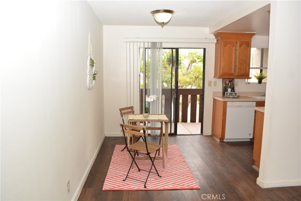 Up to $35K in potential purchase assistance. VA approved complex. Light and bright, upstairs condo in Paramount Plaza community. Paramount Plaza is a very quiet community and well maintained. The exteriors were all recently painted. This condo has an open floor plan and a 70 square foot, semi-private balcony. Tree top and neighborhood views from kitchen and balcony. Newer plank laminate floors throughout home are in good condition and are easy to care for. Oak cabinets in Kitchen are updated, they are not original builder installation. Kitchen features include refrigerator/freezer, dishwasher, garbage disposal, gas range, and hood with fan and lights. Primary suite will fit a king bed and has south facing view. Primary bathroom is 3/4 with large step-in shower. Secondary bedroom is east facing and is also good sized. Hall bath features shower over tub. Both bedrooms have been freshly painted with neutral color scheme. Home is already wired for cable and security system. Secure community, with intercom system at walk-in gate, and gate controlled parking area. Condo has two parking spaces: one covered carport with built in storage and a second assigned, uncovered space. Elementary and middle schools, Salud and Meadows Parks, and Home Depot less than 1/2 mile away. Downtown Paramount is a little over a mile.