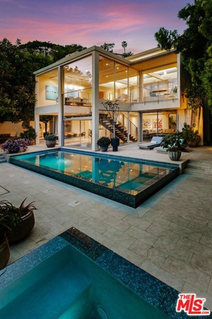 The perfect coupling of modern sophistication & California indoor-outdoor lifestyle.  The epitome of lifestyle & architecture in the coveted Bird Streets of the Sunset Strip/Hollywood Hills. Walls of glass allow you to enjoy vus of The Strip, Century City and the ocean. Enormous glass windows open remotely allowing sunlight in, offering a view through the home to the spacious backyard with a heated patio, fire feature sitting area, and beautiful pool & spa. Gourmet chef's kitchen with top-of-the-line appliances, center-island, and sleek cabinetry throughout.  The open living and dining rooms lead to a floating staircase that seamlessly connects to the lower level family/media room, wet bar and outdoor areas. Spacious Master suite takes advantage of the views through a floor-to-ceiling interior window with a switch-light privacy.  Stunning master bath with soaking tub and very large closet complete the master suite. There are also 2 additional bedrooms each opening to the outside.