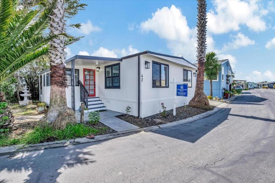 New lower price!! This home has been completely remodeled with gorgeous finishes, and ready for a new owner!  The moment you walk into this home,you are greeted w/ an enclosed porch area,that is perfect for a home office,hobby area, or a cozy place to read a book.Then you enter the main house that has an open floor plan.The kitchen Island with stainless steal 1 bowl sink is perfect to add stools so your guest can visit. The quartz counter tops are gorgeous, and there is ample counter tops to display your nice pieces, sit your food out, even have a bar area. There are new dual pane windows also. The laundry hook ups are conveniently located off the kitchen too. There are brand new stainless steel appliances, new flooring through out, can lighting, it's like a brand new home!The bathrooms have tile floors, beautiful custom showers, and vanity's. There are dual sinks in the primary bathroom also. There is a walk in closet in the primary bed/bath as well. 3 bedrooms, and 2 full baths, make this a great size home.Aslider off the primary bedroom is perfect to slip out & enjoy the sunny/private backyard. You will love this home! Low annual State registration as well,no property taxes!Monthly space rent is $3674. Come see this home,you will love it!Age restrictions,call listing agent.