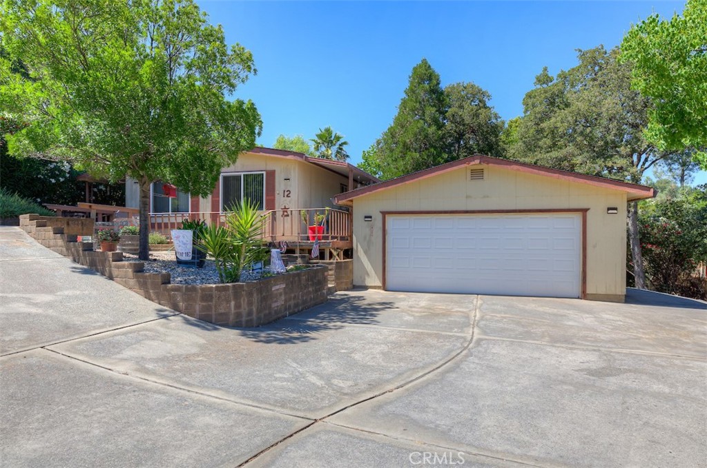 Welcome to this charming 2-bedroom, 2-bathroom manufactured home in the highly desired Kelly Ridge area near Lake Oroville. This home is located on a quiet cul-de-sac on a large, 0.28-acre lot. As you approach this home you will notice the tasteful landscaping and ample parking in front of the home and the large, detached garage. Covered porches on both sides of the home are connected by a deck that wraps around the front of the home and was built to be handicap accessible. The home offers a spacious living room that connects to the kitchen and dining area. There is also an additional family room with a gas fireplace and a slider that exits outside onto the deck. The large primary bedroom connects to its own private bathroom with dual sinks and a large soaking tub. In addition to covered porches outside the home, there is also a deck area overlooking the back yard perfect for relaxing and enjoying the private setting. A seasonal stream also runs along the back part of the property. Solar panels that are located on the garage can also help to keep your energy bills lower. Don't hesitate to call and set up your showing!