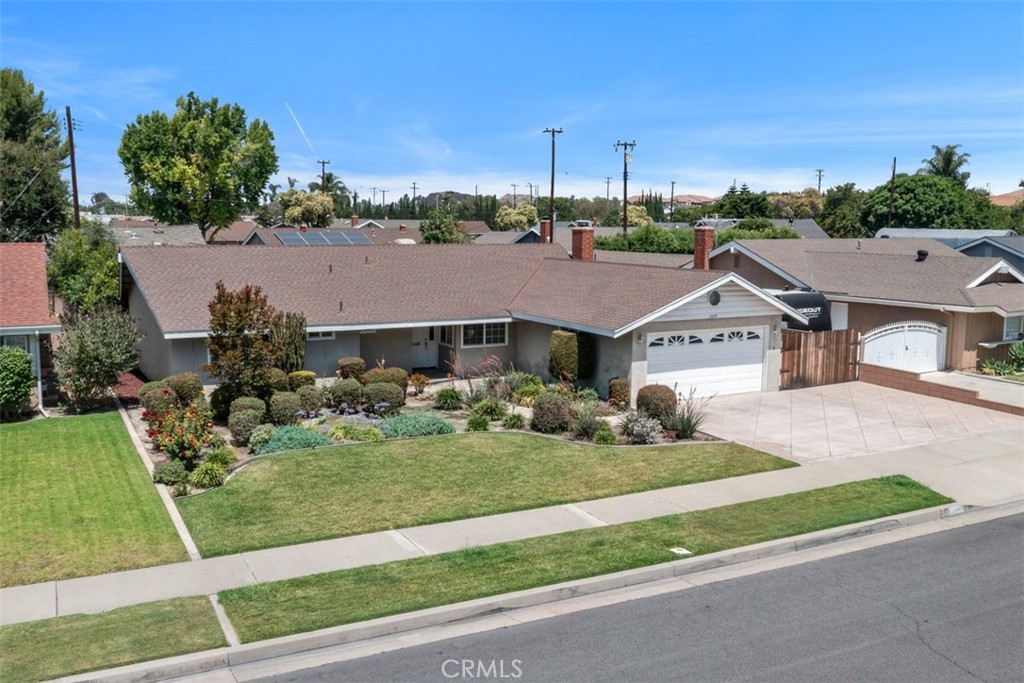 Great single family home in the middle of a quiet street. This single level floor plan has newer wood flooring throughout and a new roof as of 2024. Kitchen has granite counter tops, pull-out drawers and gas oven/cooktop. Lots of cabinets for storage. Ceiling fans in most bedrooms and the dining room. Bathrooms have granite countertops. Large 8500sqft lot has an extensive drip system to manage the abundant landscaping in front and rear yards. Large patio cover with fans to enjoy the peaceful backyard. 2 Car garage plus parking for 3 additional cars in the driveway and gated RV/boat parking. Easy access to the 55 & 91 freeways and very close to Disneyland and Angel Stadium.