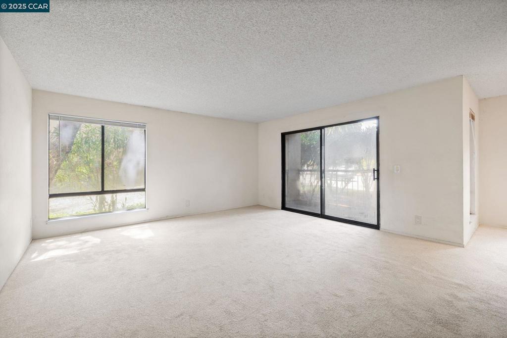 Unlock the potential in this 2-bedroom, 2-bath ground-floor condo located in Walnut Creek’s resort-style community, The Keys. This property offers lots of opportunity, with a spacious & versatile layout for those ready to renovate and customize. The living and dining areas flow seamlessly to a private patio—perfect for creating an indoor-outdoor retreat. A galley-style kitchen offers the chance to reimagine the space with modern update. The two bedrooms are thoughtfully positioned on opposite sides of the unit, providing privacy and flexibility for guests, housemates, or a dedicated home office. The primary suite includes an ensuite bath and walk-in closet, while a hall bath serves the second bedroom and main living area. Enjoy resort-style living with access to three swimming pools, spas, tennis courts, fitness center, clubhouse, sauna, ping pong, and tranquil greenbelt paths with fountains. Just minutes from downtown Walnut Creek’s vibrant shopping and dining scene, BART, parks, top-rated schools, and major highways. Whether you're an investor or homeowner with vision, this is an opportunity to create something special in an unbeatable location.