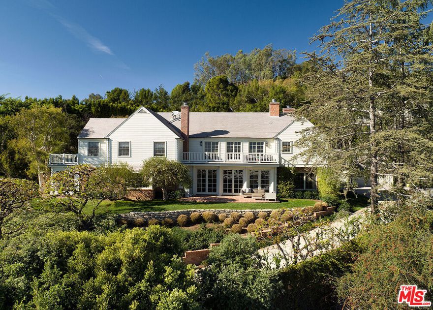 Sited on over 3/4 of an acre in the heart of Brentwood, one finds a most charming and exquisite Gerard Colcord compound. Up a long-gated driveway, the large motor court sets the tone for this exceptional estate. Mature trees, charming courtyard and rolling grassy lawns compliment the magnificent views. Main house features a soaring 2-story entry foyer with beautiful paneling. Adjacent living room opens to a large terrace, perfect for entertaining. Large Formal dining room with fireplace. Sun-filled Gourmet kitchen with banquette breakfast nook. Primary suite is the ultimate retreat, with incredible views, soaring ceilings, marble bath and 2 large closets. Grounds include pool house with catering kitchen and an additional 2-story guest house. Minutes to the city - yet the feeling of being removed and in nature. Shown only to prequalified buyers.