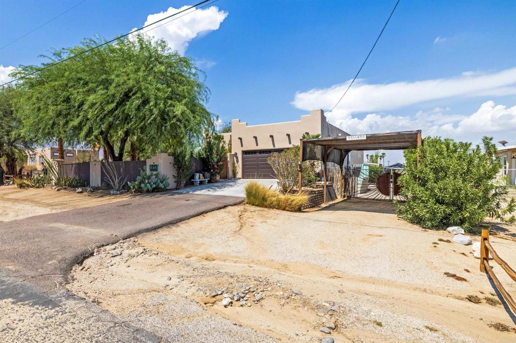 Step into the spirit of the Southwest with this beautifully maintained 3-bedroom, 2-bath home nestled on a spacious 0.36-acre lot. Designed for both comfort and functionality, the open floor plan welcomes you with rich plank vinyl flooring, solar tubes that bathe the interior in natural light, and a cozy wood-burning fireplace that anchors the living space. The kitchen shines with granite countertops and seamless flow into the living and dining areas—perfect for entertaining or quiet evenings in. Outside, enjoy the privacy of a fully fenced front and back yard, complete with mature landscaping that adds texture and tranquility. The covered back patio offers a shaded retreat, flanked by handy storage sheds and room to relax or garden. For adventurers and hobbyists, gated RV parking with 110 amp service provides convenience and flexibility. This home is a true blend of style, substance, and Southwest soul