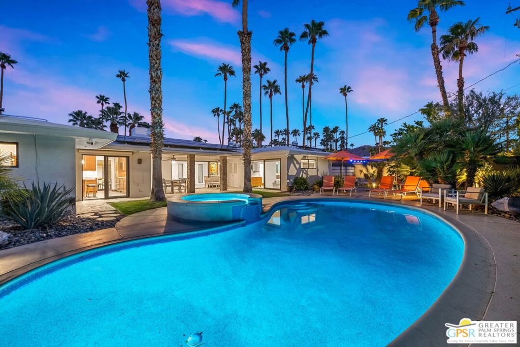 Welcome to your modern desert sanctuary in the highly desirable Deepwell neighborhood, where timeless Palm Springs style meets sleek contemporary upgrades. From the moment you enter, open-concept living spaces invite you in. Expansive Fleetwood Infinity sliders let the line between indoors and outdoors disappear creating a seamless flow to your private resort-style backyard. Entertain with ease on the covered patio, take a dip in the saltwater pool & spa with waterfall, gather around the firepit, or cool off under the full misting system, all while soaking in iconic west-facing mountain views. The chef's kitchen is pure indulgence: quartz countertops, custom cabinetry, a Wolf six-burner range, Sub-Zero stainless refrigerator, and built-in wine fridge. Every bedroom is en-suite and fitted with California Closets, double rolling shades, and stylish new window coverings. Brand new motorized shades come equipped in the primary and living room area. No detail has been overlooked: brand new TV/Audio sound systems have been installed in all bedrooms, updated AC vents, Lutron dimmers, wallpaper accents, Ring camera, all new Kohler toilets, epoxy-finished temperature-controlled garage, and 35 OWNED solar panels for added efficiency. Tech meets comfort with a variable-speed HVAC, electric car charger, and a new pool pump. Even the smallest touches include new recessed lighting, custom TV niche, fresh paint, drywall repair, all safety features throughout the home and more were thoughtfully reimagined. This home isn't just beautiful: it's smart, efficient, and built for modern living. All brand new furniture (never been lived in) can be available outside of escrow. On fee-simple land, this property is ideal as a primary residence, vacation getaway, or high-performing short-term luxury vacation rental (neighborhood is still currently under 20% capacity, verify with city). This Deepwell stunner delivers the ultimate Palm Springs lifestyle where every day feels like a getaway.
