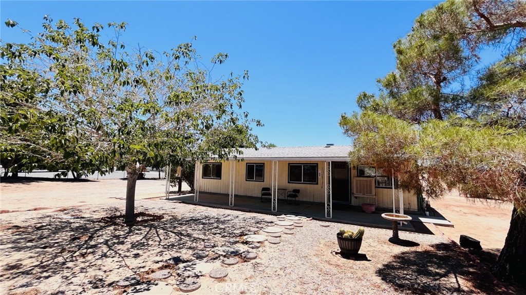*Cozy and full of charm* This 2 bed, 2bath Manufactured home sits on a permanent foundation and offers 1,056 sq ft of comfortable living space. You'll love the adorable front porch, perfect for morning coffee or desert sunsets. Inside features include a wood-burning stove, indoor laundry room, and two spacious bedrooms. This home sits on 1.07 acres with plenty of room to spread out. Outside you'll find a detached 2-car garage, a large shipping container with plenty of storage space, a wood shed & a low maintenance landscape. Located just off the pavement, not too far from town, this little cutie would make a great starter home, desert getaway, or homestead with with room to grow. Schedule a viewing today and envision high desert living!