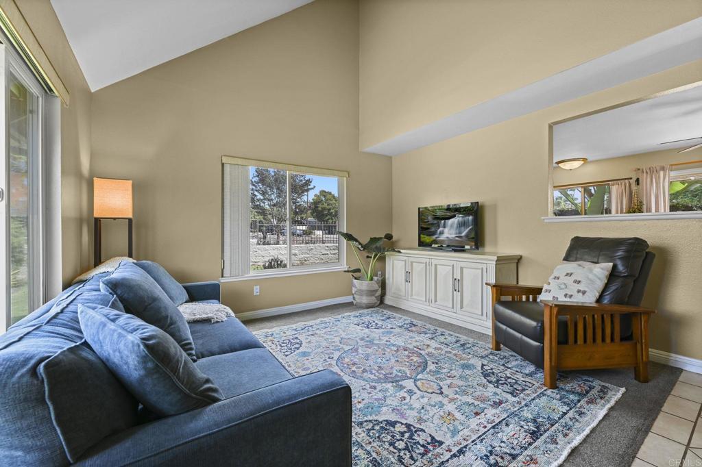 Welcome to Citrus Park, a gated community tucked right in the heart of Vista. This end-unit townhome has soaring ceilings, an open layout, and natural light pouring in from every angle. The kitchen is fresh and functional with modern appliances and a sunny south-facing window that makes mornings feel brighter. Step outside through the sliding doors to your private covered patio, framed with tropical landscaping that stays beautiful without demanding your weekend. It’s the perfect spot to unwind with a book or entertain friends on a warm evening. Upstairs, both bedrooms are roomy with vaulted ceilings and plenty of light. The primary suite is especially spacious, offering comfort and flexibility to create your own retreat. They’re connected by a well-kept ensuite bath that ties the space together. Being an end unit has its perks — including a large grassy side yard that feels private and is perfect for play, pets, or simply stretching out in your own green space. You’ll also enjoy an attached garage with epoxy floors, a second parking space in the driveway, and a third assigned spot for good measure. Add in interior laundry, a sparkling community pool, and nearby parks and you’ve got all the practical perks covered. And the best part? You’re just a short walk to downtown Vista with its mix of restaurants, coffee shops, and fun nightlife.