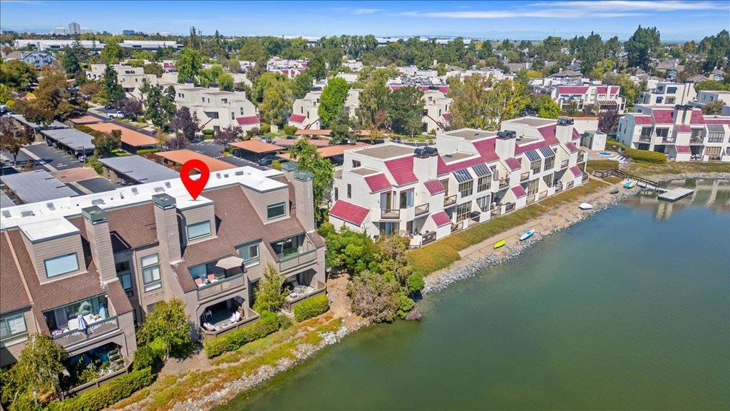 Welcome to Redwood Shores coveted Pelican Cove complex. Rare wide water location with panoramic views of lagoon calm waters. Scenic path loops around for walking, biking, and enjoying views of the surrounding natural beauty and wildlife. With 820 square feet of living space, this property is ideal for those seeking a balanced lifestyle with modern conveniences. Kitchen with refaced cabinets, new stainless steel appliances(2025) and LED recessed lights. Spacious living room with wood-burning fireplace, large sliding glass door to private patio/deck with spectacular water views, a perfect spot for hot summer al fresco dining or morning coffee. Remodeled bath with natural stone tub surround, vanity, washlet/bidet, new plumbing fixtures. Stackable LG washer and dryer (2024) inside. One-car deeded carport parking. Residents will appreciate the community amenities, incl. two pools, hot tub, boat dock, beautiful park-like grounds, guest parking. $735/mo HOA dues cover hot water, trash, roof, reserves, two pools, hot tub, management, common area maintenance, and landscaping. Don't miss the opportunity to make this delightful home yours! Great location convenient to Hwy 101 access, Bay Club, Market Place, Redwood Shores Elementary & library, and much more.