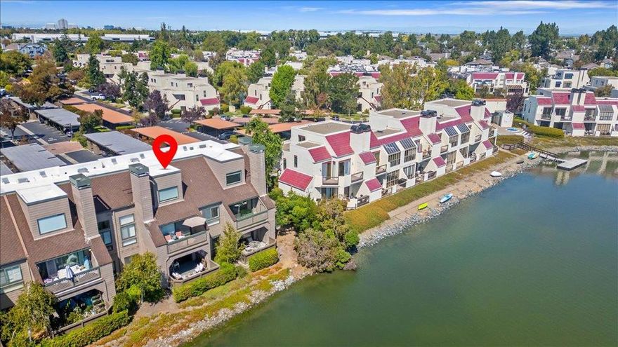 Welcome to Redwood Shores coveted Pelican Cove complex. Rare wide water location with panoramic views of lagoon calm waters. Scenic path loops around for walking, biking, and enjoying views of the surrounding natural beauty and wildlife. With 820 square feet of living space, this property is ideal for those seeking a balanced lifestyle with modern conveniences. Kitchen with refaced cabinets, new stainless steel appliances(2025) and LED recessed lights. Spacious living room with wood-burning fireplace, large sliding glass door to private patio/deck with spectacular water views, a perfect spot for hot summer al fresco dining or morning coffee. Remodeled bath with natural stone tub surround, vanity, washlet/bidet, new plumbing fixtures. Stackable LG washer and dryer  (2024) inside. One-car deeded carport parking. Residents will appreciate the community amenities, incl. two pools, hot tub, boat dock, beautiful park-like grounds, guest parking. $735/mo HOA dues cover hot water, trash, roof, reserves, two pools, hot tub, management, common area maintenance, and landscaping. Don't miss the opportunity to make this delightful home yours! Great location convenient to Hwy 101 access, Bay Club, Market Place, Redwood Shores Elementary & library, and much more.