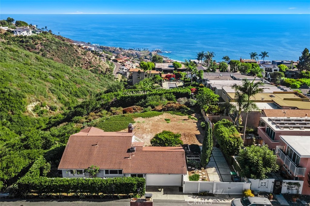 A unique bulk sale of three separate parcels in Laguna Beach—1285 Cortez Ave, 829 Miramar St, and 855 Miramar St. All three sites are confirmed buildable per municipal code and county records, making this an exceptional opportunity for investors, builders, or visionaries. The Cortez parcel currently features a charming single-story 2 bedroom, 2 bathroom home with sweeping ocean and canyon views. Enjoy a tranquil garden setting complete with a dwarf avocado tree and fruit cocktail tree, offering a peaceful retreat. Nestled on a quiet street with no streetlights, evenings here are serene and uninterrupted. Whether you envision developing multiple custom homes, designing a private coastal compound, or holding the parcels as a long-term investment, the possibilities are endless. This is a rare chance to own three prime properties in one of Laguna Beach’s most desirable neighborhoods.