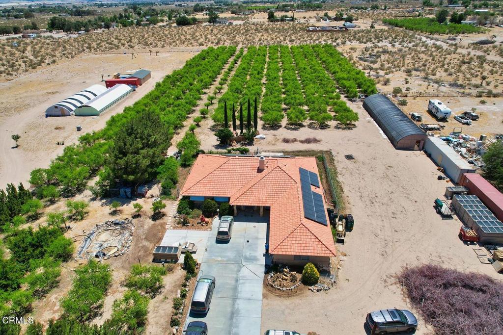 Nestled on 3.57 acres in the heart of Lucerne Valley, this unique farm-style property offers a perfect blend of rural tranquility and agricultural potential. Built in 1992, the spacious 2,304 sq ft home features 3 bedrooms, 2.5 bathrooms, a generous living area, dining room, office, island kitchen, and a laundry room. The primary suite includes a walk-in closet, dual sinks, a soaking tub, and separate shower for a true retreat experience.Agricultural highlights include a 24x96 ft greenhouse, 300 mature jujube trees, two 45 ft shipping containers, and a workshop. The farm is equipped with an efficient irrigation system and liquid fertilizer delivery for streamlined operations.The property features a leased solar system with 48 panels, helping reduce environmental impact while keeping utility costs manageable. Monthly payments for the solar system are based on actual energy production and usage, offering a flexible and eco-conscious energy solution. A private well and septic system add to the property's self-sufficiency.Additional features include a 3-car garage, wide parking area, full fencing with an automatic gate, and location within a designated agricultural zone that may offer farming support programs. What makes this opportunity exceptional is the ability to live on-site while generating substantial annual income--a rare find in today's market. Ideal for those seeking both self-sufficiency and profitability, this property combines a peaceful lifestyle with real earning potential.