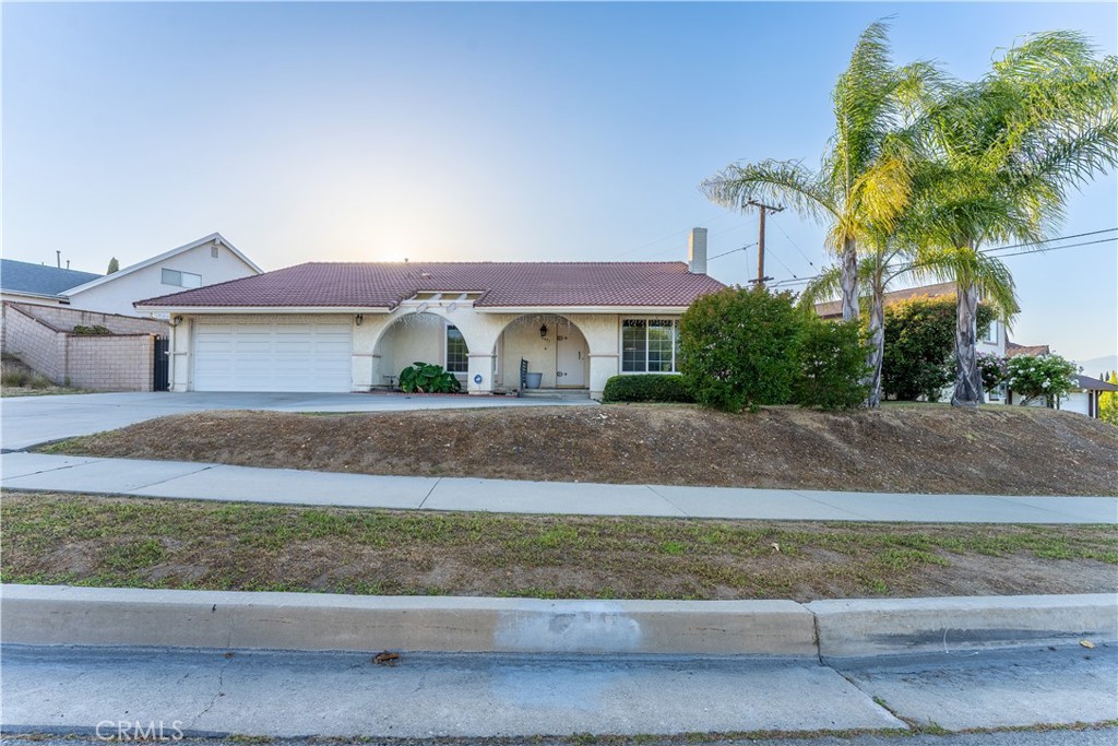Located in the highly desirable area of Hacienda Heights, this beautiful Spanish style home with tile roof has been lovingly maintained. The 4 bedroom, 2 bath single-level home has a living area of 1909 square feet on a 9,722 square foot lot with a view of the San Gabriel mountains. As you enter the ceramic tiled foyer, the formal living room is warm and inviting with natural light, a brick fireplace, cathedral ceilings and a formal dining room. The wood laminate flooring is throughout the living room, family room, hallways, bedrooms and closets. The spacious family room with cathedral ceilings is next to the open kithchen and has direct access to the large backyard with covered patio. Four bedrooms include a master bedroom with bathroom and walk-in closet. All windows and doors are double paned and have new faux wood blinds throughout. Additional improvements include a new a/c unit, a new water heater, and recessed lighting in the kitchen and bathrooms. The attached 2-car garage has direct interior access and an insulated garage door. Thomas Burton Park is within walking distance. And close by there is shopping, dining, the AMC movie theater and the 60 frwy.